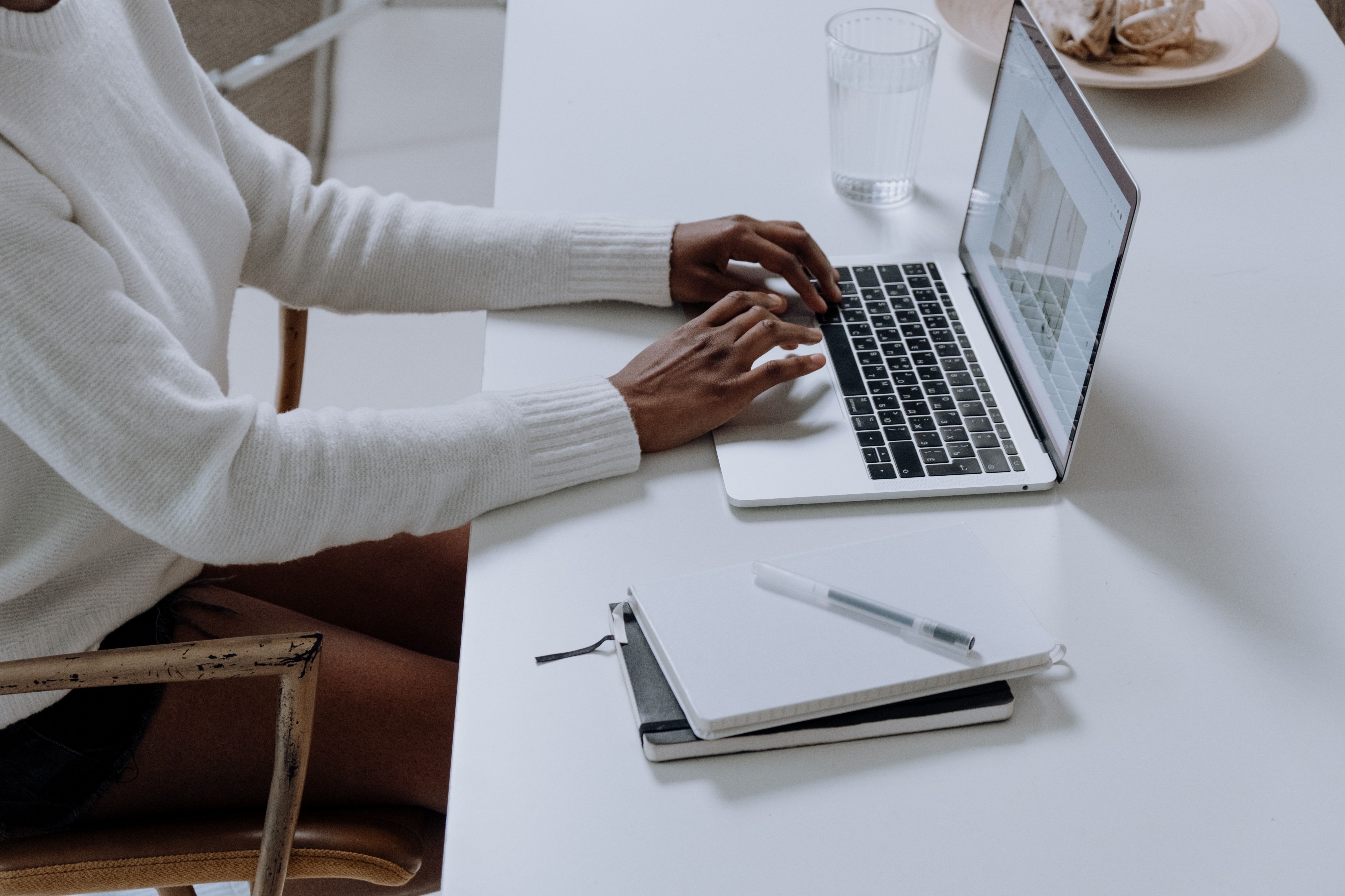 woman typing at table with notebook.jpg